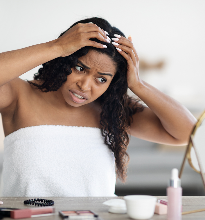 Woman checking and caring for her scalp during winter